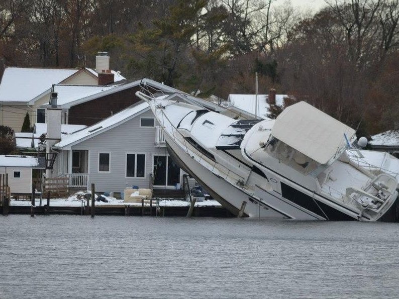 Vessel driven onto a residential dock after a coastal storm